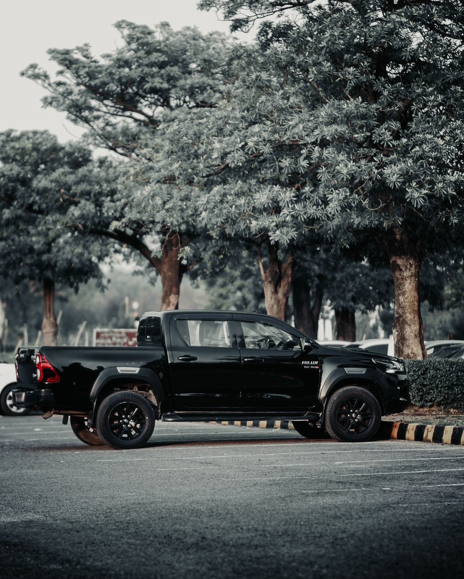 Black Toyota Hilux Revo pickup, side view